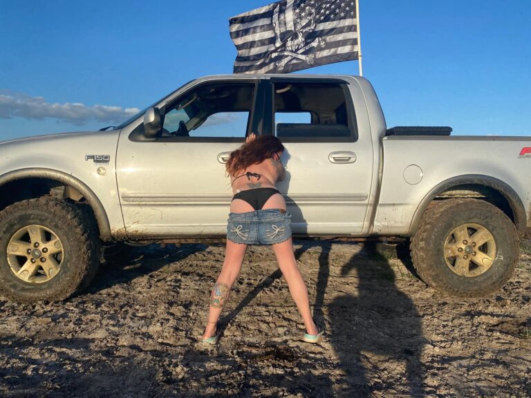 Lifted truck, flag flying, muddy day