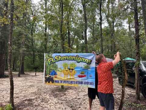 Hanging the FL Shenanigans banner at camp