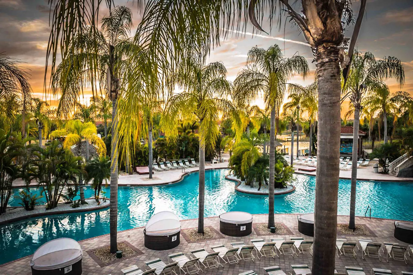 The main pool at Caliente Resort at sunset